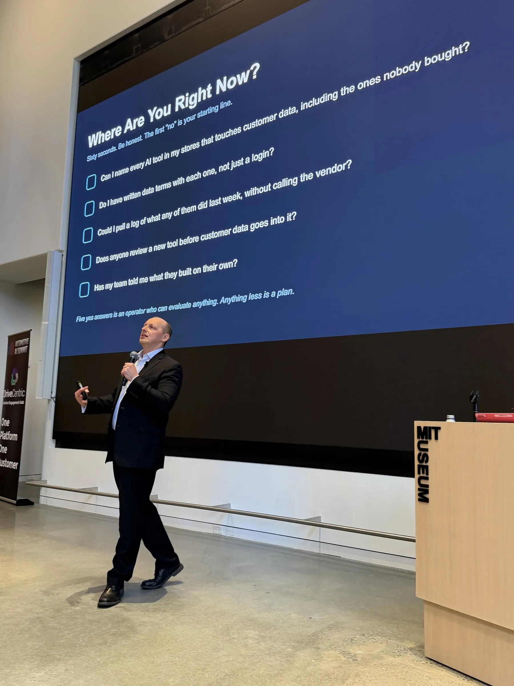 Yuriy Demidko mid-talk at the MIT Museum, microphone in hand